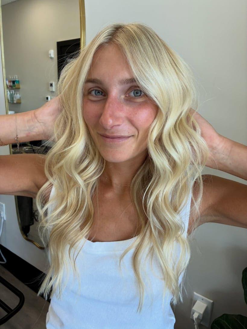 Bright lived-in blonde with soft face-framing brightness and long waves, front view — hair by Alchemy Loft