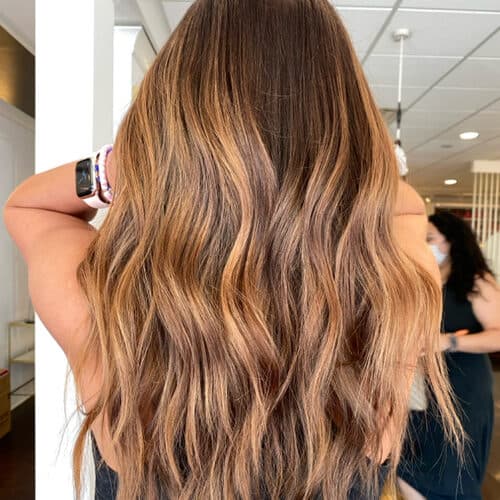 Copper-blonde balayage with long waves, back view — hair by Alchemy Loft