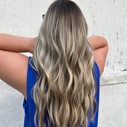 Ash blonde balayage with long waves, back view — hair by Alchemy Loft