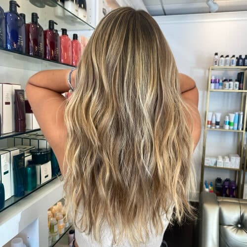Blonde balayage with long waves, back view — hair by Alchemy Loft